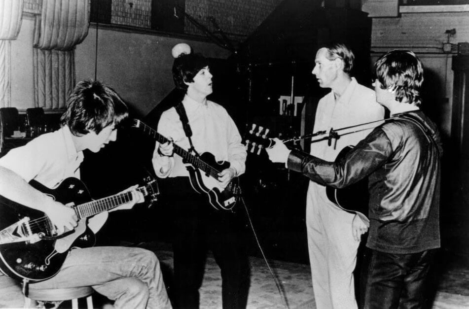 English record producer George Martin with The Beatles