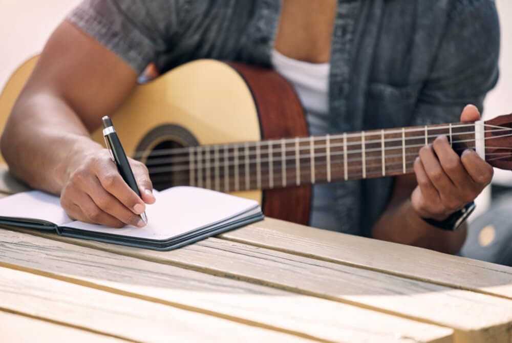 musician writing lyrics and music
