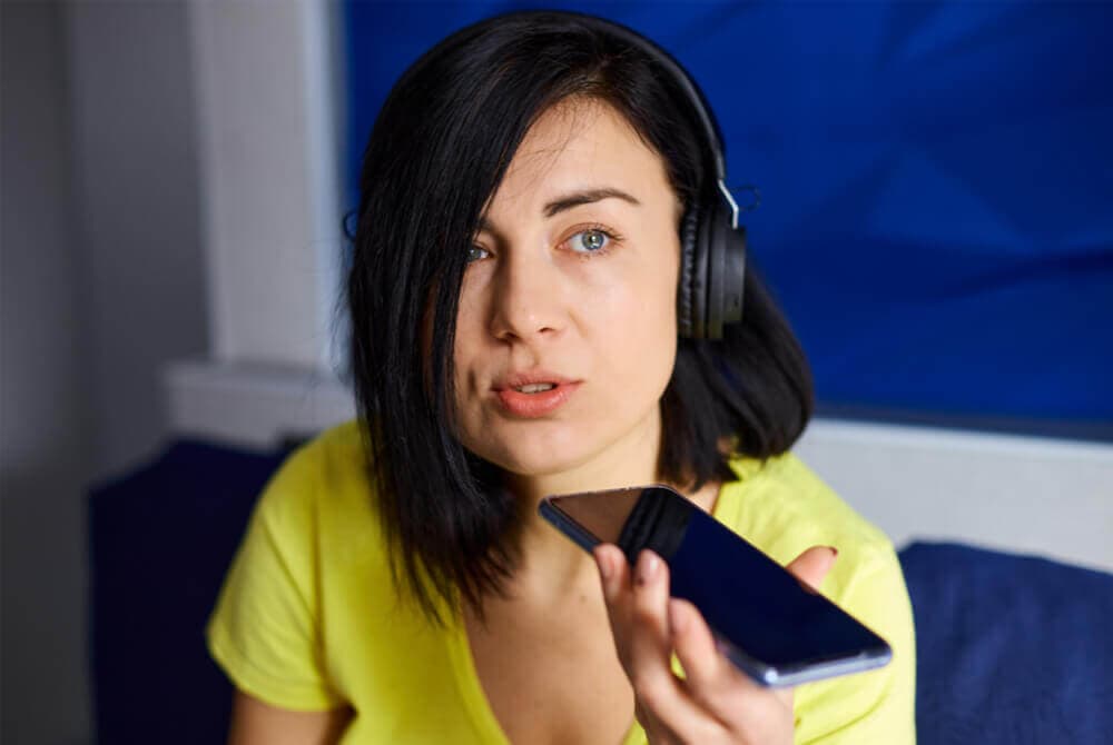 female musician recording wordless melody on phone