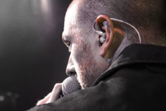 vocalist using Shure in-ear monitors on stage